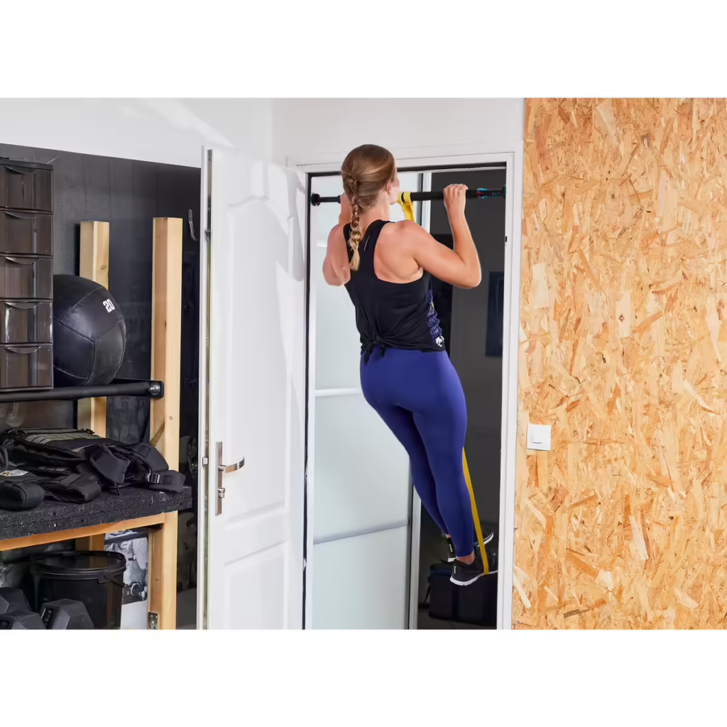 Femme faisant des tractions assistées aux élastiques sur une barre de tractions pour cadres de portes